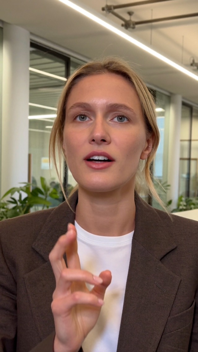 A founder talking to camera in an office, with a name tag and captions